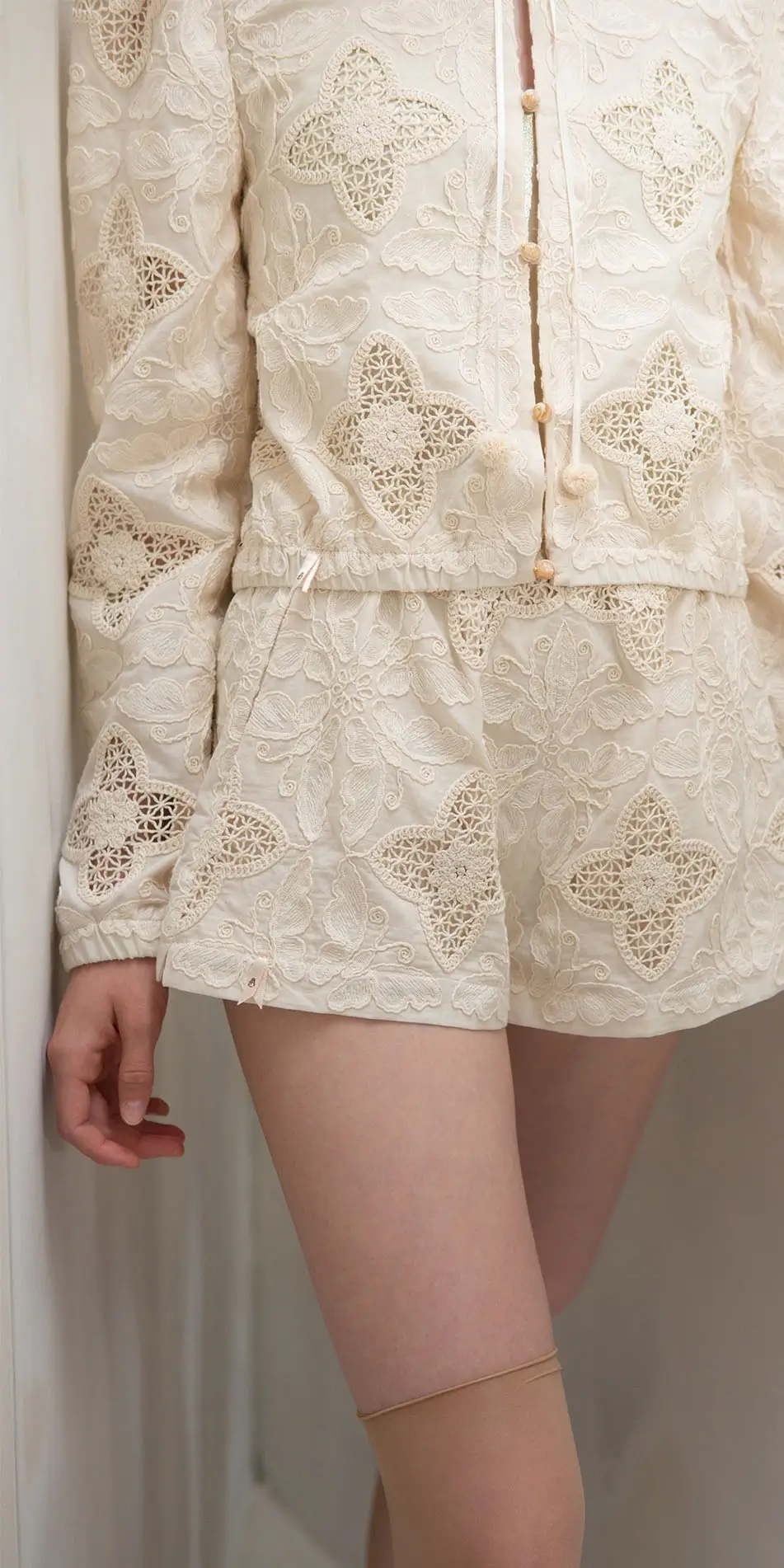 Round neck embroidered cotton jacket in cream front cropped waist