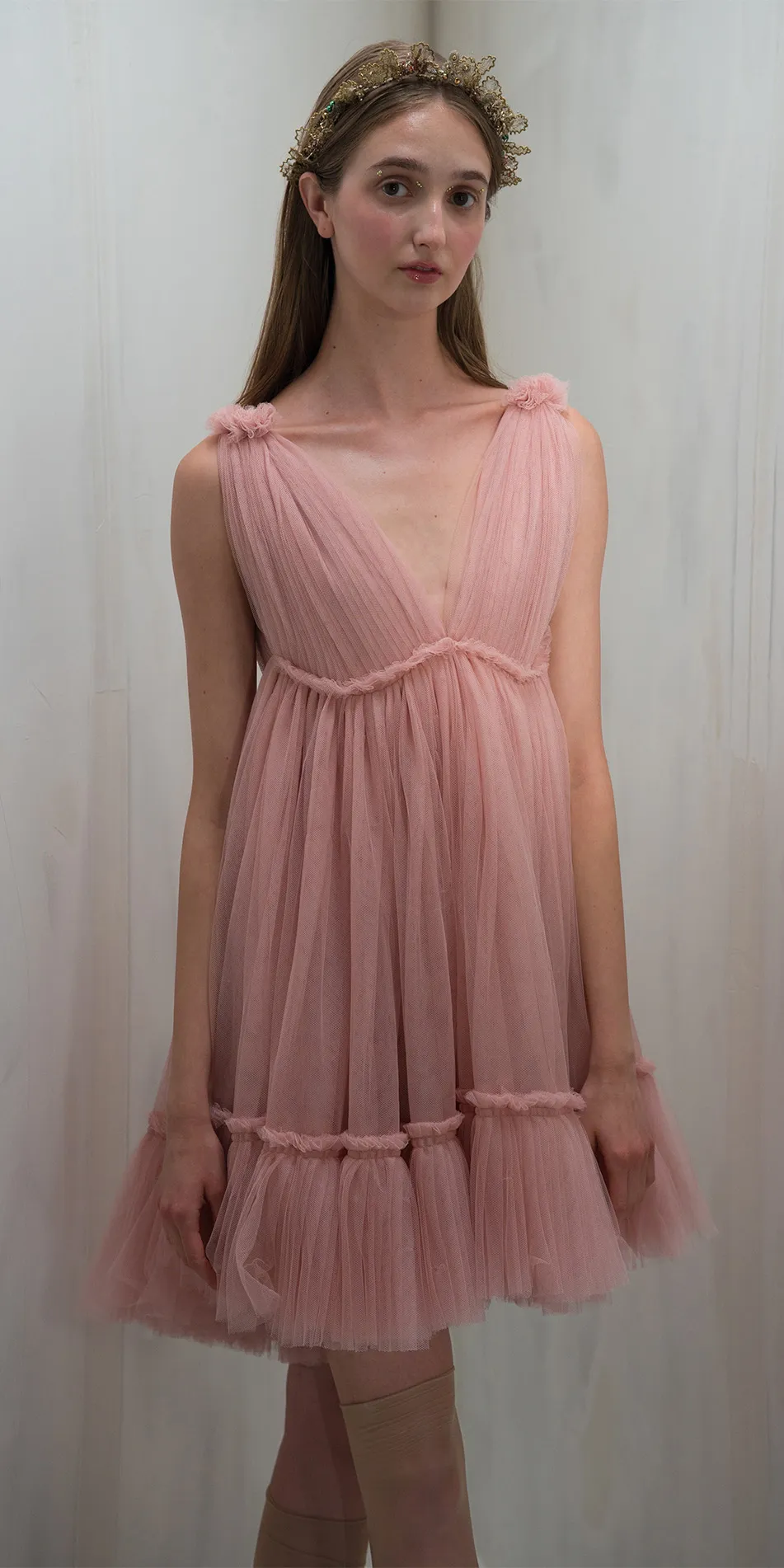 Tulle split neck babydoll dress in dusty pink front cropped legs crossed