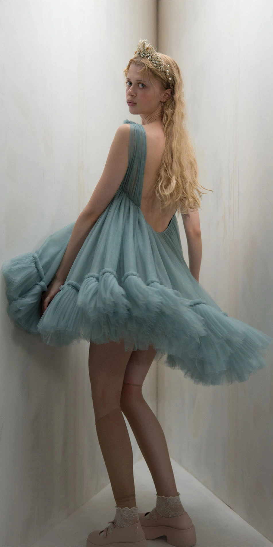 Tulle split neck babydoll dress in light blue back looking over shoulder