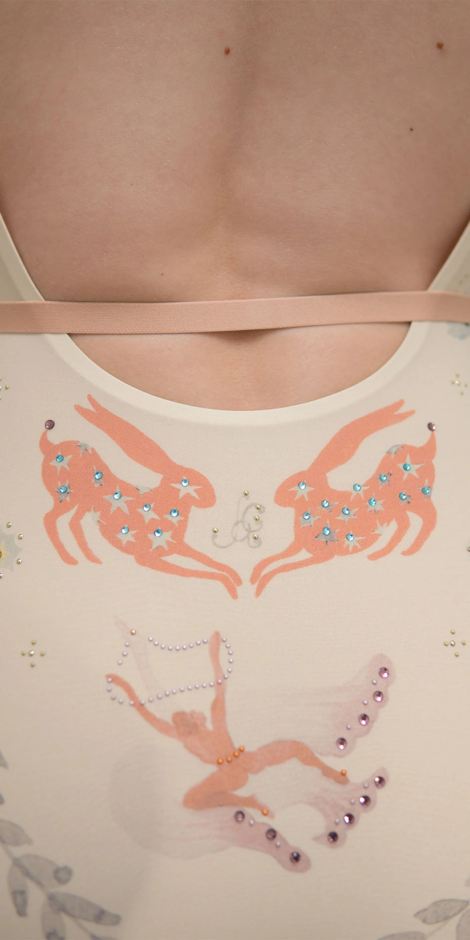 Printed boatneck leotard with rhinestones in cream back cropped looking over shoulder